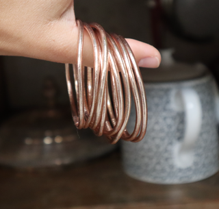 Modelo llevando el Pack de 10 pulseras finas Pippa Gold